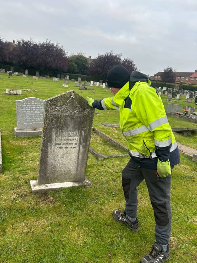 Head Gardener and Cemetery Superintendent Stephen undertaking headstone safety testing in Butterwick Road Cemetery.